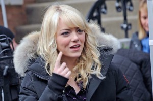 Actress Emma Stone wearing a Canada Goose jacket on set (2013, Getty)