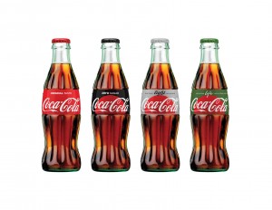 This photo provided by The Coca-Cola Company shows the new appearance of Coca-Cola bottles. Coca-Cola says it is giving cans and bottles of its flagship sodas a makeover, with plans to unify the appearance of regular Coke, Diet Coke, Coke Zero and Coke Life. (The Coca-Cola Company via AP) MANDATORY CREDIT