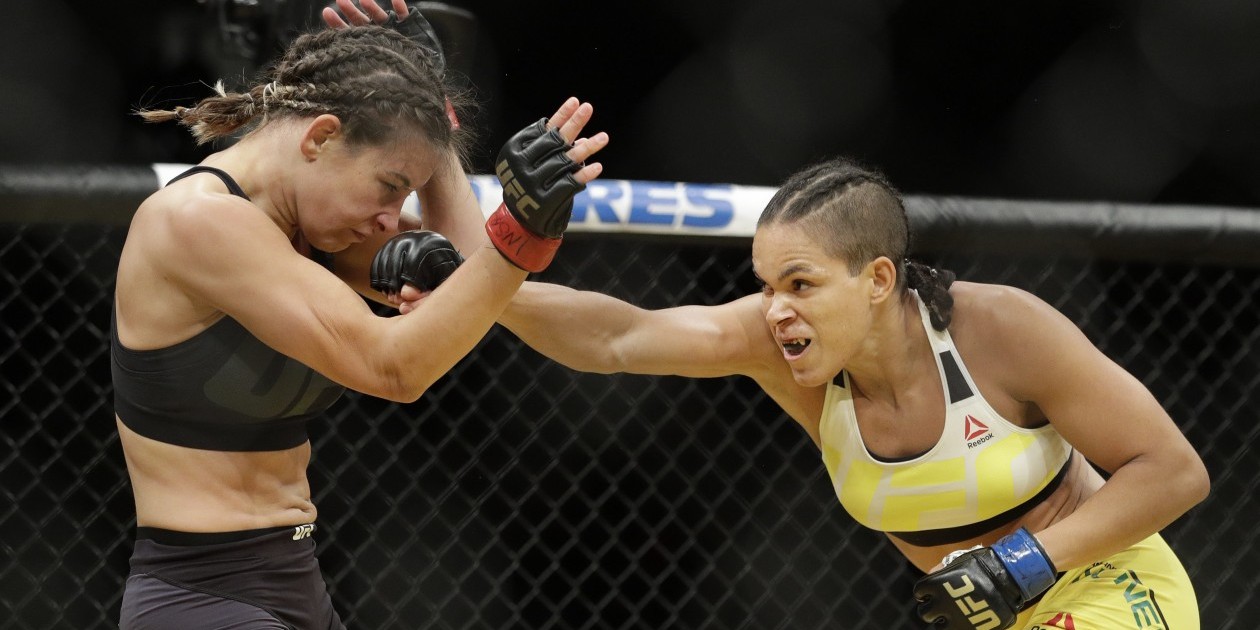 Amanda Nunes, right, hits Miesha Tate during their women's bantamweight championship mixed martial arts bout at UFC 200, Saturday, July 9, 2016, in Las Vegas. (AP Photo/John Locher)