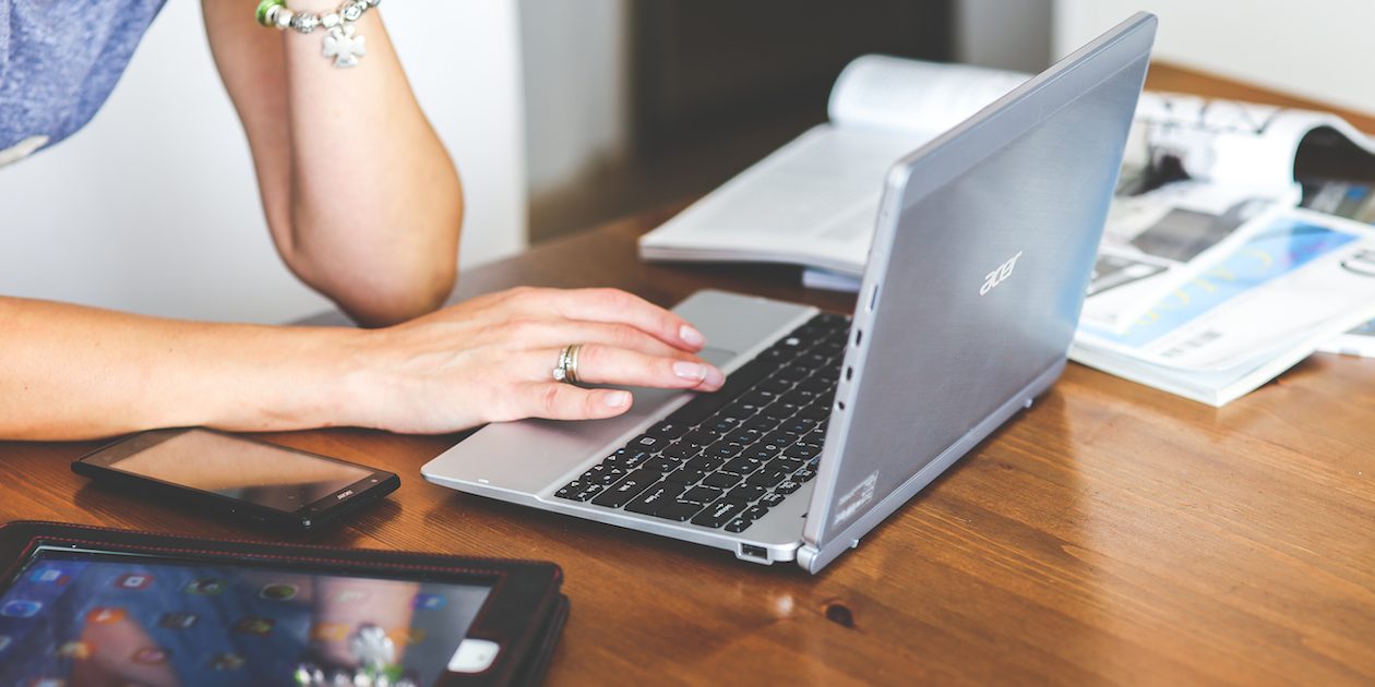 woman-hand-smartphone-laptop