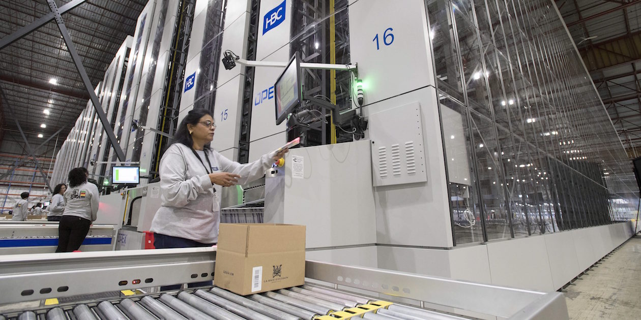 A Hudson Bay's worker boxes items picked by the company's new robotic fulfillment system in Toronto on Friday November 4, 2016. THE CANADIAN PRESS/Frank Gunn